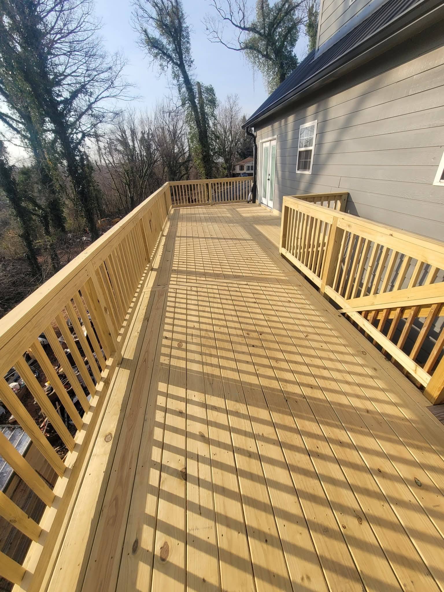 Fresh pressure-treated deck surface with railings